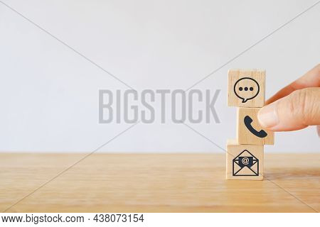 Senior's Hand Choose Telephone Icon On Square Wood Cube For Contact Us, Communication, Consultation,
