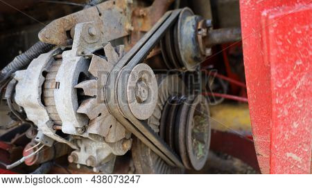 Old Belt On Alternator. Old Black Belt On Pulley Drive Charger Or Engine Alternator With Copy Space.