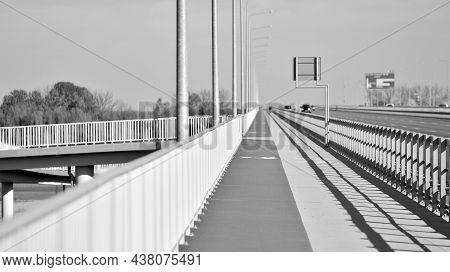 Bicycle Path And Sidewalk Through The Highway Bridge. Black And White.