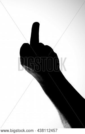 Black And White Image Of Silhouette Of Hand Showing Middle Finger In Fuck Off Gesture