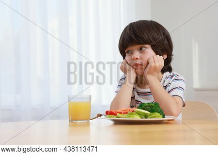 Cute Little Boy Refusing To Eat Vegetables At Home, Space For Text