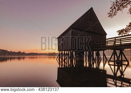 A Old Fisherman House With A Sunrise In The Background