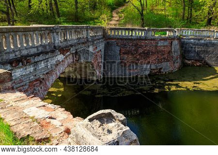 Old Arched Brick Bridge Across A Pond In Sharovka Palace Park In In Kharkov Region, Ukraine