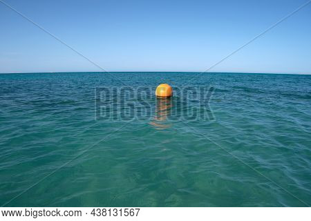 Yellow Buoy Floating On Sea Surface As Marker For Swimming Restriction In Deep Water At Tropical Res