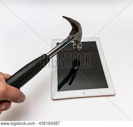 Hand With A Hammer Breaks The Tablet Computer. Broken Glass Tablet Repair.