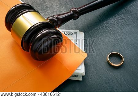 Divorce And Alimony Concept. Gavel And Wedding Ring.