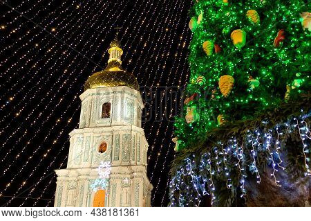 Beautiful Scenic Decorated Christmas Tree With Decorations And Illuminated By Light Garlands Against