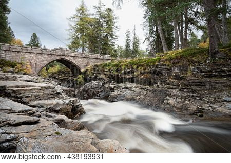 The Stone Bridge That Goes Over The Rapids Of The River Dee In The Cairngorms Mountains Of Scotland