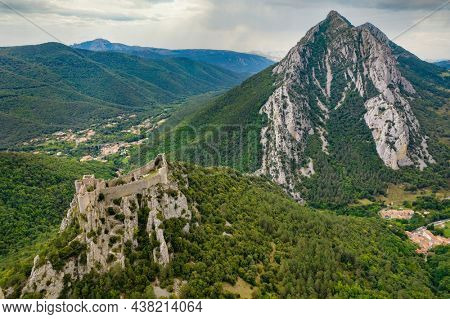 Aerial shot showing the Medieval Puilaurens castle and the Canigou mount in the Pyrrenees mountain, France