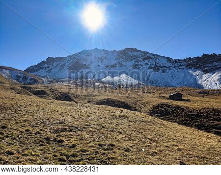 Farmhouse In The Mountains Above Monstein, Davos. Beautiful Autumn Landscape With Snowy Mountain Pea