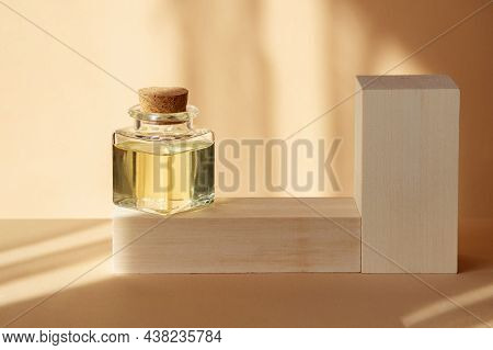 Mock-up Of Square Glass Bubble With Essential Oil In Rays Of Sunlight On Wooden Stands. Close-up, Be