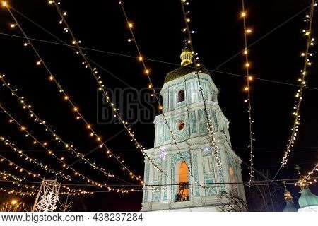 Beautiful Scenic Decorated Christmas Tree With Decorations And Illuminated By Light Garlands Against