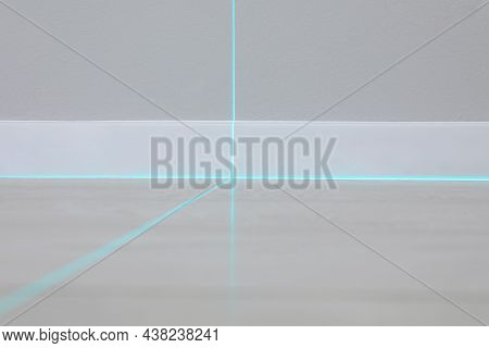 Cross Lines Of Laser Level On Wall And Floor Indoors