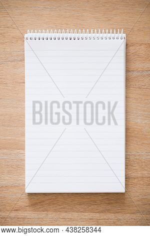 White Secretary Notepad Open On A Wood Desk. Background Or Template With Copy Space On Empty Noteboo
