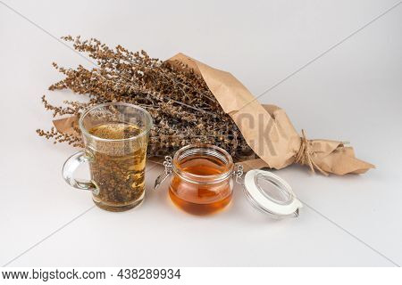 Herb Tea, Honey And Wormwood Twigs Wrapped In Brown Paper.