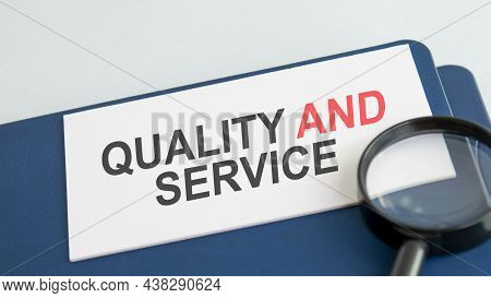 Quality And Service Word On Paper And Magnifying Lens