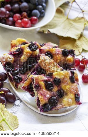 Traditional Italian Yeast Dough Pie With Grapes Schiacciata And Bunches Of Grapes On A Light Backgro