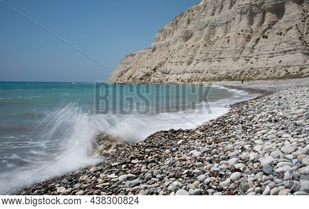 Empty Pebble Tropical Beach Under White Cliffs Against Blue Sky. Pissouri Coastline Limassol Cyprus 