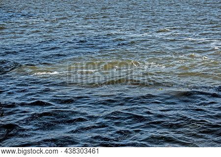 Dirty Orange Water From Sewage Pipeline Mixes With River Water.