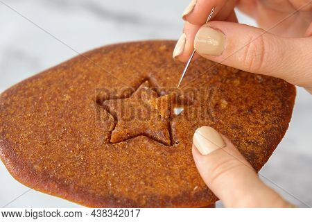 Kiev Ukraine - October 2021 Playing Korean Dalgona Or Ppopgi Honeycomb Candy From Squid Game Challen