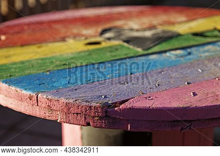 Rainbow Colored Table Made Of An Old Wooden Spool From Construction Site