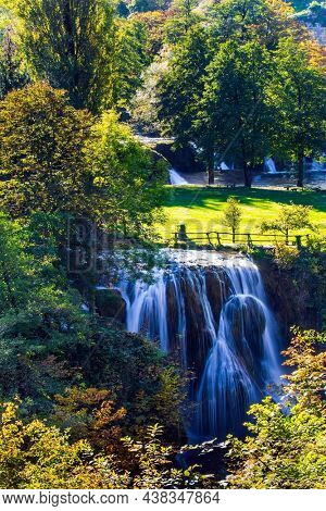 Travel to Croatia. The Croatian town of Slunj. Cascade of waterfalls on the Sluncica River. Sunny lawn at the waterfall. The concept of ecological, active and photo tourism