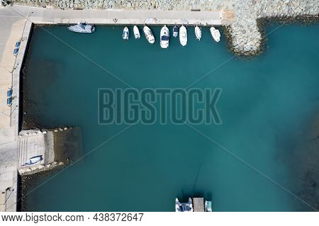 Aerial Drone View Of Fishing Boats Moored At The Harbor. Moored At Breakwater. Pyrgos Marina Cyprus 