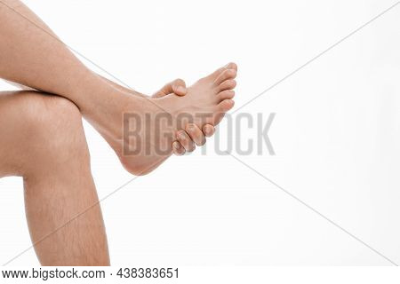 Unrecognizable Millennial European Man Athlete Massaging His Leg And Suffering From Foot Pain