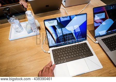 Paris France - Sep 24 2021: Male Hand Testing New Apple Computers Macbook Book Pro 16 Inch Laptop Fe