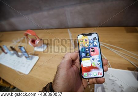 Paris, France - Sep 24, 2021: Male Hand Holding New Iphone 13 Mini At The Apple Store With All Apps 
