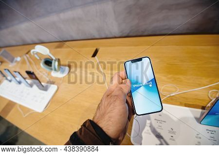 Paris, France - Sep 24, 2021: Male Hand Holding New Iphone 13 Mini At The Apple Store As Latest 5g I