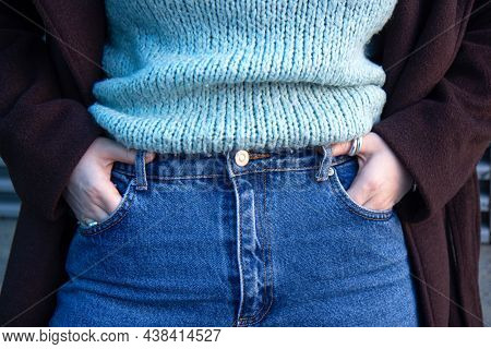 Woman In A Dark Coat, Warm Sweater And Jeans. Close Up. Noface
