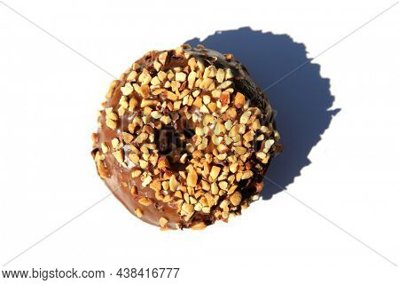 chocolate Donut with peanuts. isolated on white. room for text. clipping path. People world wide enjoy donuts. Enjoy a Donut today.