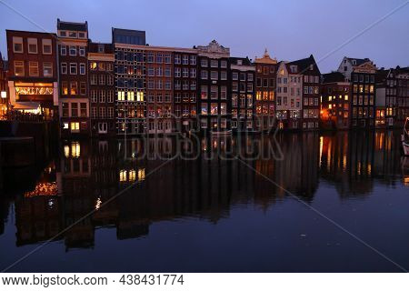 Amsterdam, Netherlands - December 6, 2018: Before Dawn Damrak Canal Reflection In Amsterdam, Netherl