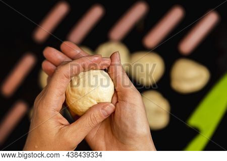 Women's Hands Sculpt A Piece Of Dough For Cooking Sausages In Dough, Cooking Hot Dogs, Female Hands 