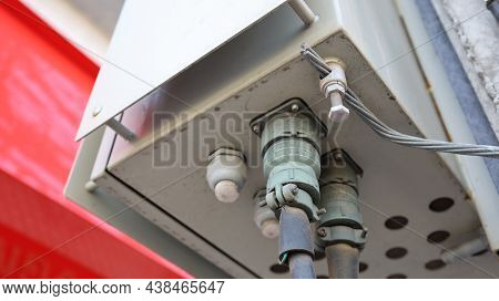 Ground Wire Under The Metal Box. A Silver Cable And Ground Nut Are Mounted Under The Control Cabinet