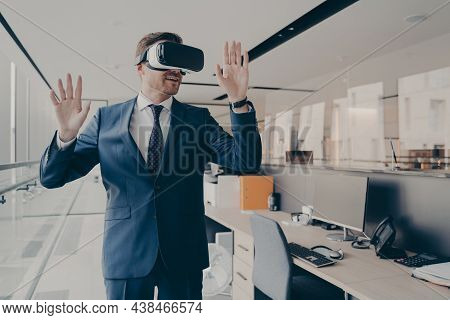 Young Man In Formal Suit Enjoying Virtual Tour Or Excursion With Vr Headset. Businessman In Virtual 