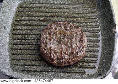 Raw Meat Ground Beef Cutlets Steak For A Burger On A Grill Pan.