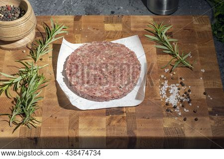 Organic Ground Beef Patties On Wooden Background