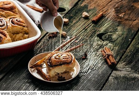 Baked Sweet Cinnamon Rolls On A Wooden Table. Sinnabon Buns Rolls. Swedish Dessert.