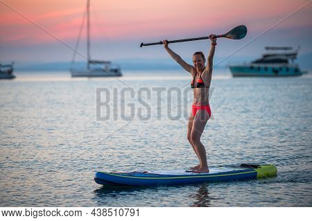 Woman Riding Sup Stand Up Paddle On Vacation.