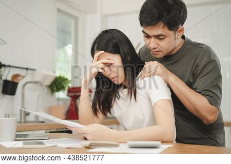 Stressed Asian Young Couple Family, Wife And Husband Confused By Calculate Expense From Invoice Or B