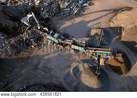 Excavator At Landfill The Load Concrete Waste In A Mobile Jaw Crusher Machine. Disposal Of Construct