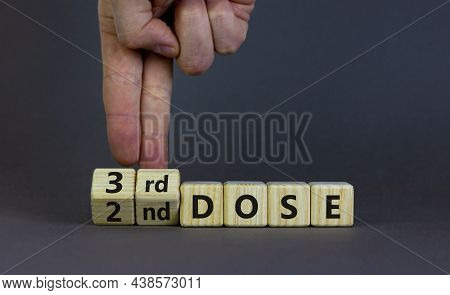 Covid-19 Booster Dose Vaccine Shot Symbol. Doctor Turns Cubes And Changes Words '2nd Dose' To '3rd D