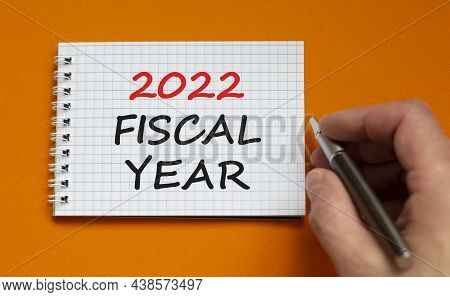 2022 Fiscal New Year Symbol. Businessman Writing Words '2022 Fiscal Year' On White Note. Beautiful O