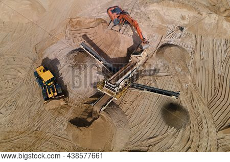 Arial View Of The Sand Open-pit Mining With Heavy Mining Machinery. Mobile Stone Jaw Crusher Machine