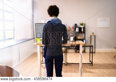 Adjustable Height Desk Stand In Office Using Computer