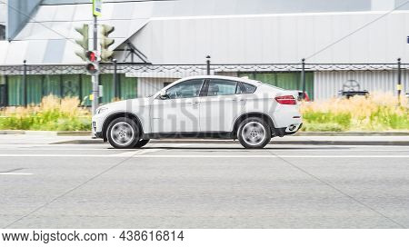 Moscow, Russia - July 2021: Side View Rolling Shot With White Car In Motion. Bmw X6 E71 Fast Driving