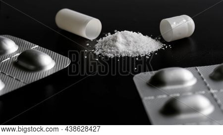 Opened White Medical Powder Capsule On A Black Background Next To Metallized Blisters. Meldonium. Ma