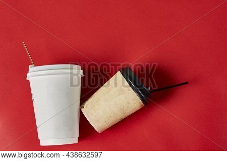 Two Single-use Plastic Coffee Cups On Red Background With Copy Space